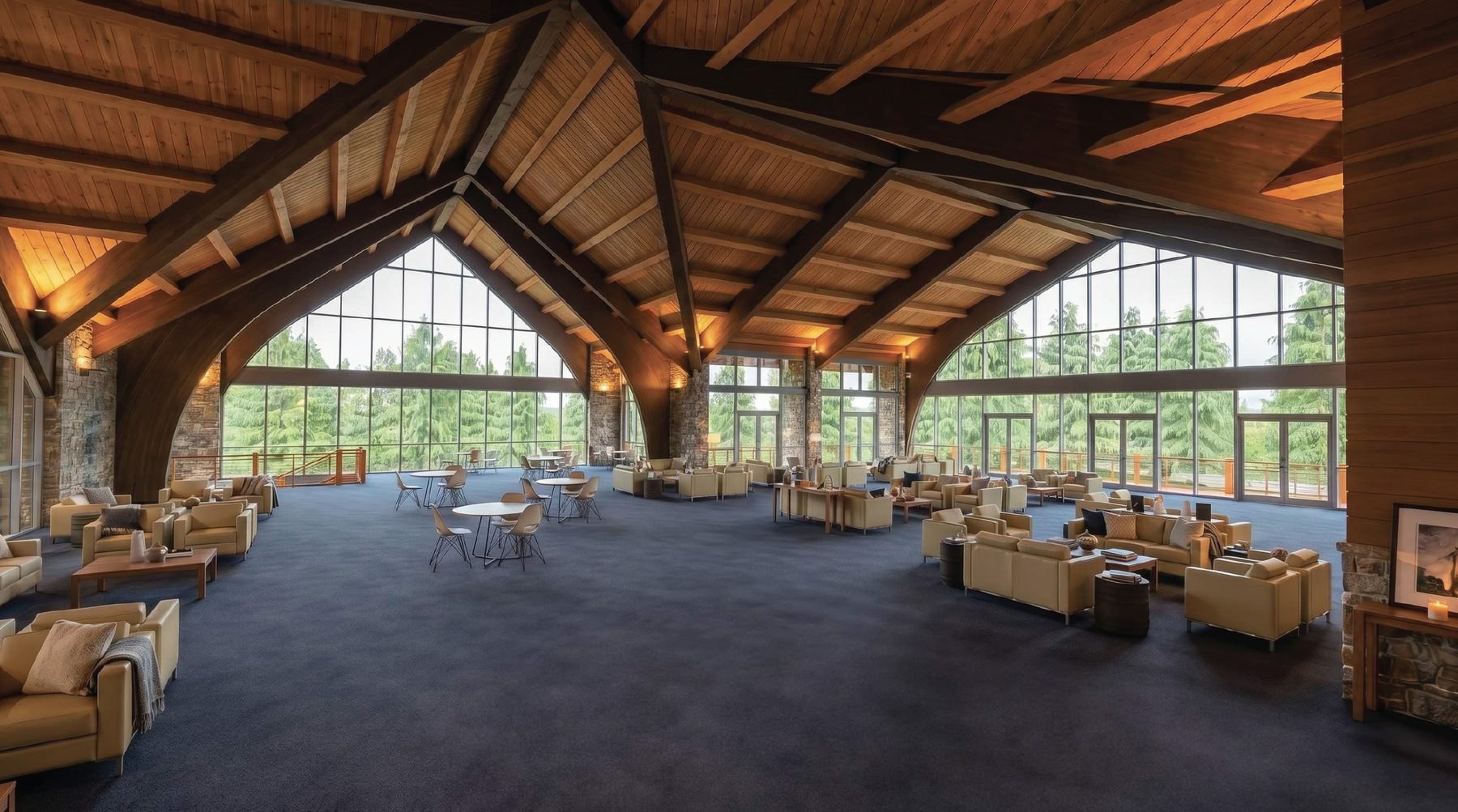 Architectural rendering of the renewed Ark interior: a wide lounge under an exposed timber roof, armchairs and café tables on dark carpet, and a full wall of windows looking out into the pines.