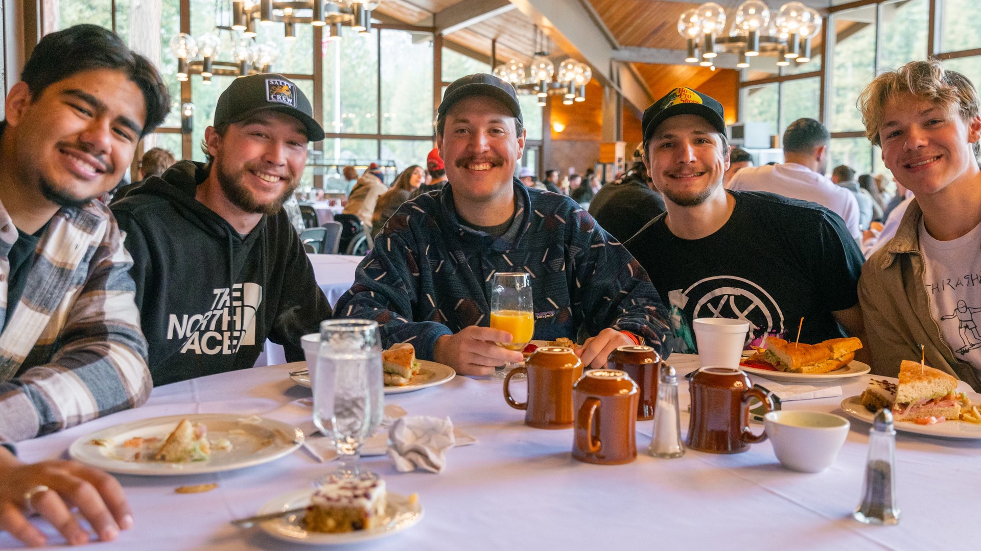 Young men gathered around a shared meal in the Ponderosa Dining Hall