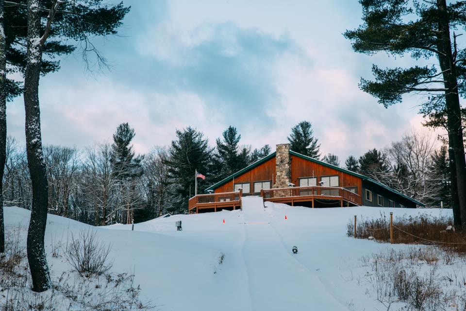 The lodge at Hume New England in snow, seen from above.