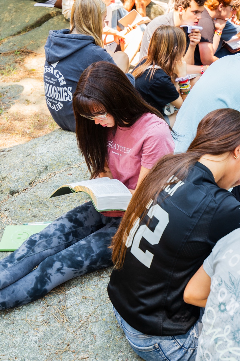 Students at Ponderosa reading their Bibles outdoors.