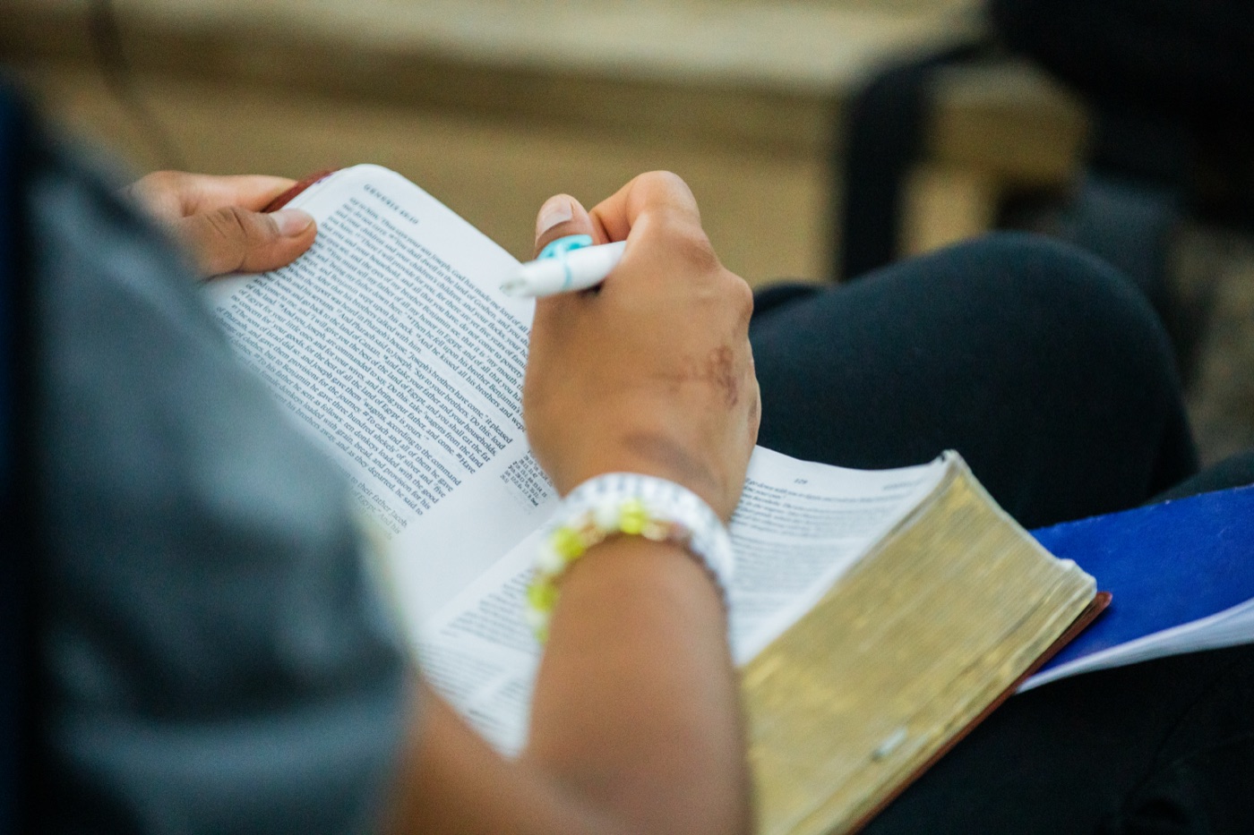 A camper writing in a Bible during a session.