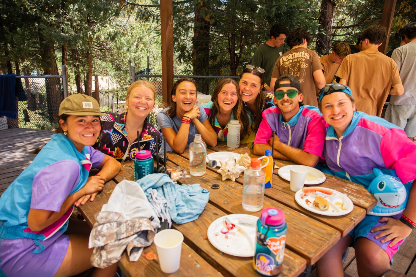 Campers at a picnic table with water bottles at Wildwood.
