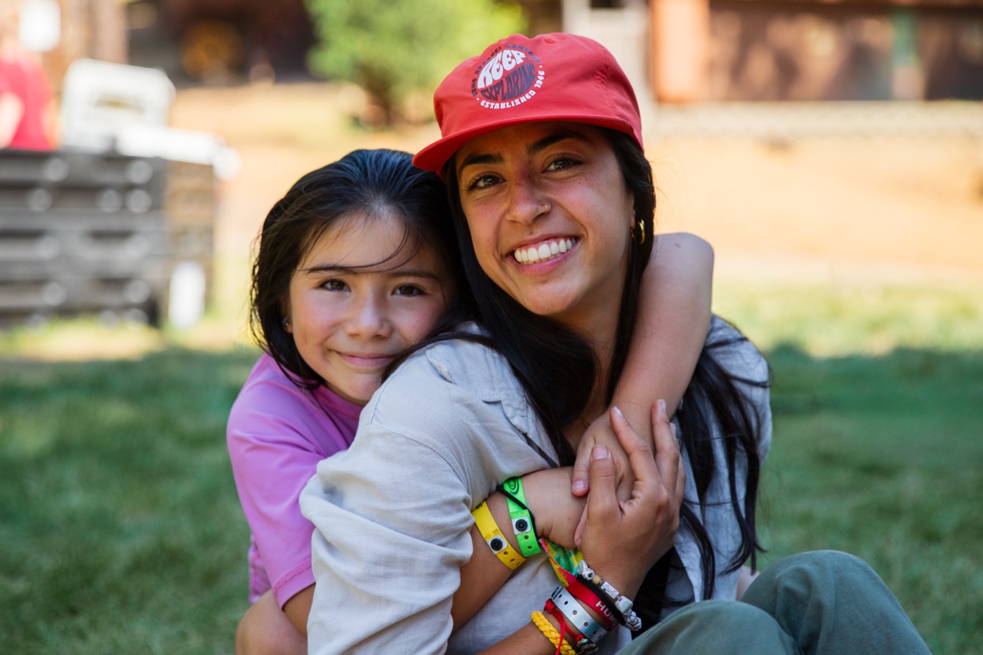 A Wagon Train counselor hugging a young camper.
