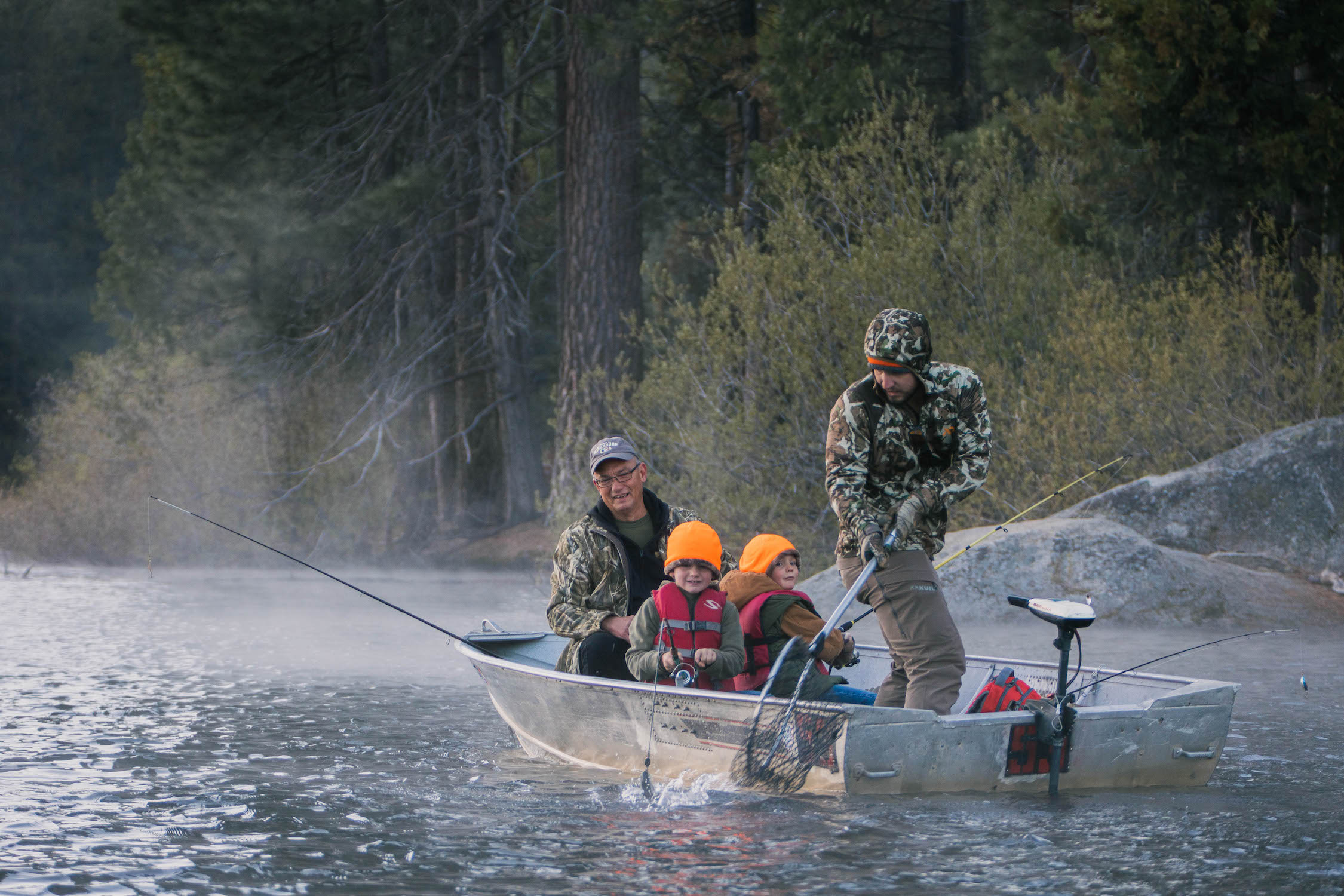 Fishermen in boat on lake