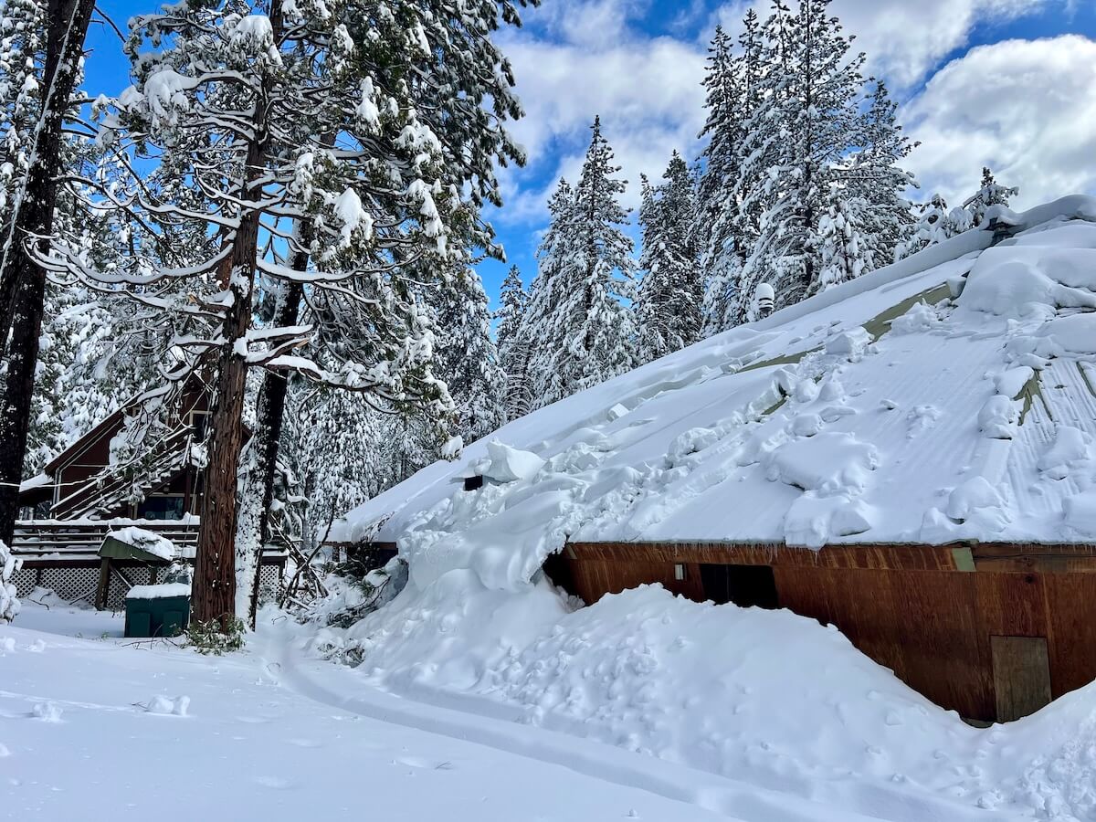 Snow piles, fallen trees and com lines at the Ark and Ranch House.